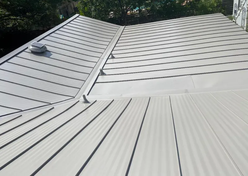 Solar attic fan installed on a metal roof for Roof Ventilation in Dearborn